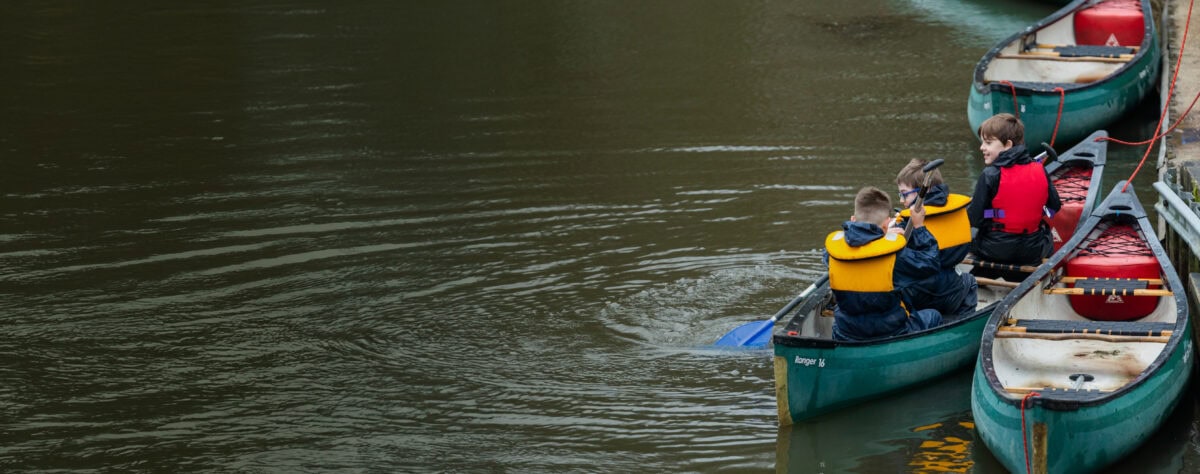 Children Canoeing At Runways End